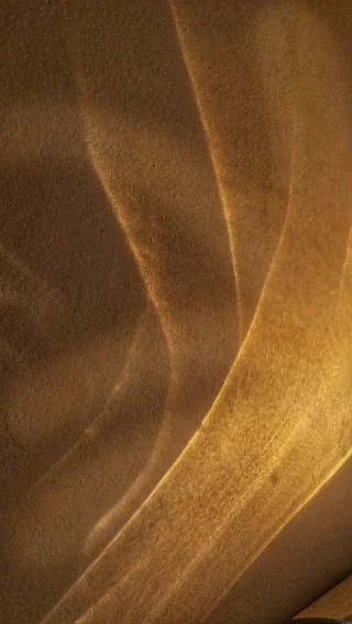 Soft folds of golden silk in low light